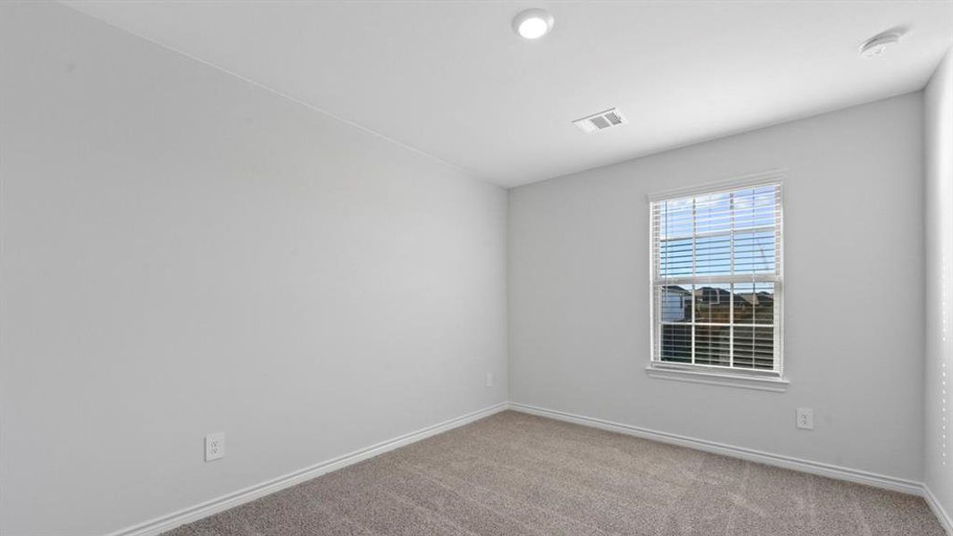 Empty room featuring light colored carpet and baseboards Empty room featuring light colored carpet and baseboards