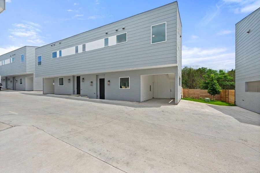 The property features modern architectural design with grey siding and contrasting white accents
