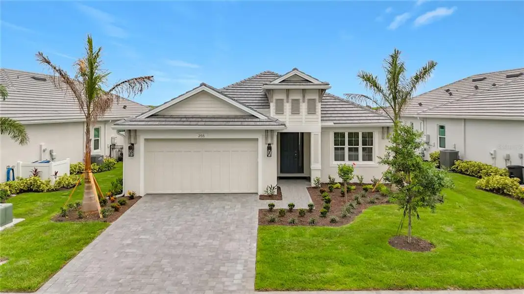 Front exterior of a new home in Watercolor Place, Bradenton, FL, highlighting curb appeal (Image 25). Front exterior of a new home in Watercolor Place, Bradenton, FL, highlighting curb appeal (Image 25).