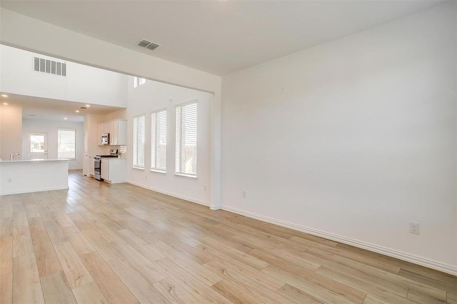 Unfurnished living room with light hardwood / wood-style floors