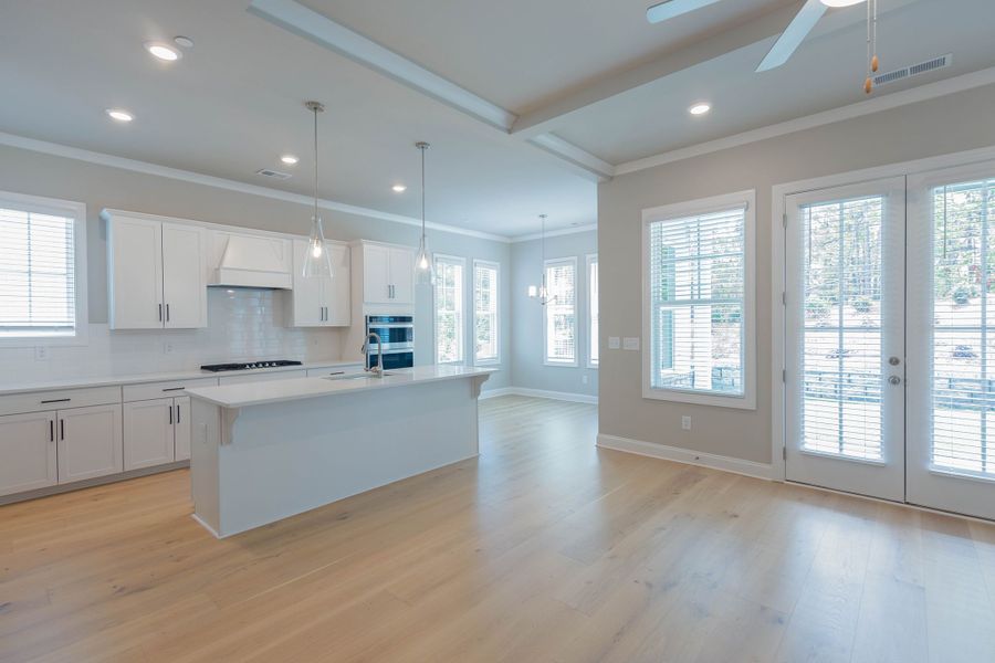 The kitchen with a center island overlooks the breakfast area and the family room