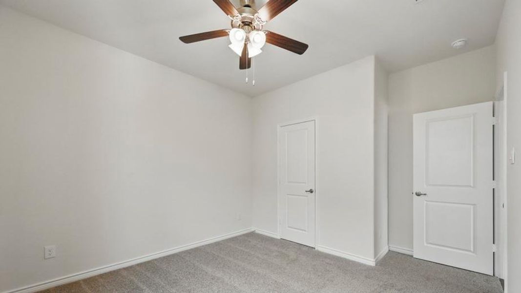 Neutral wall tones with gray carpet flooring