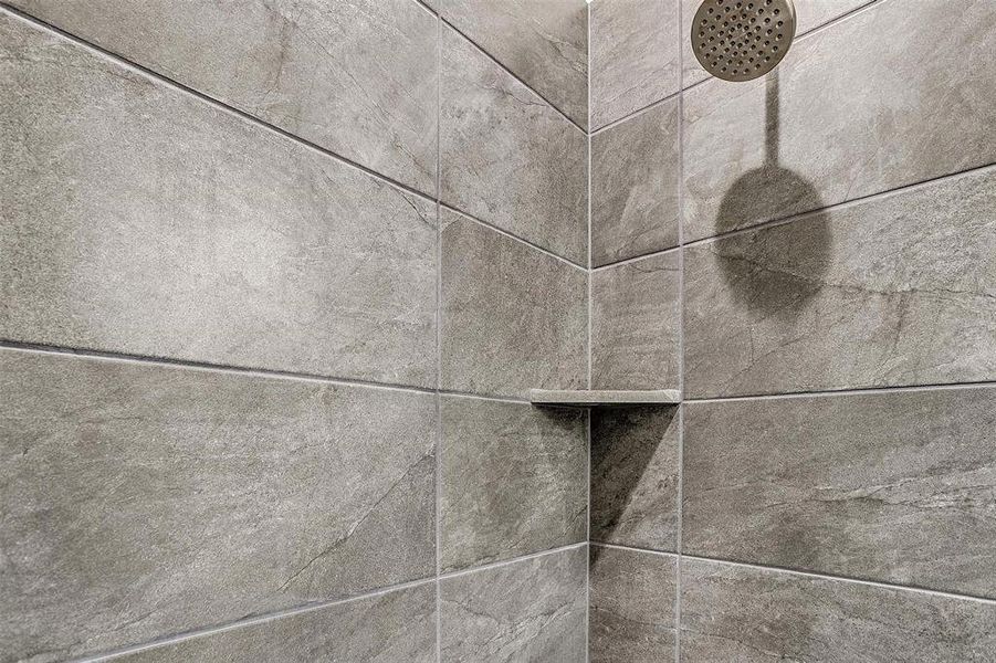 Interior details featuring a tile shower