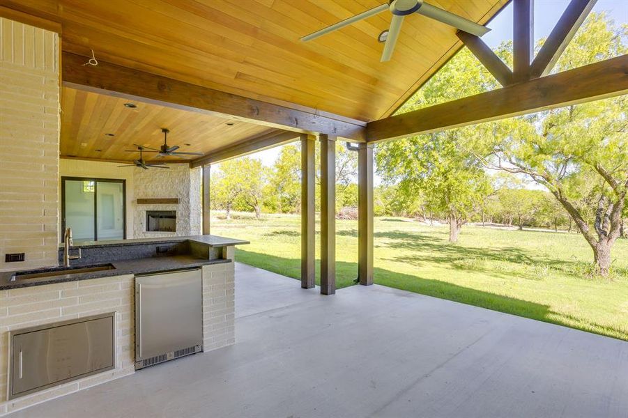 View of patio featuring a ceiling fan and an outdoor kitchen