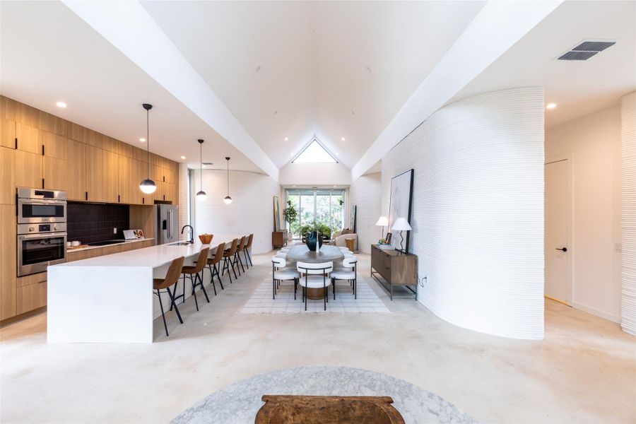 Dining area featuring concrete floors, recessed lighting, and lofted ceiling Dining area featuring concrete floors, recessed lighting, and lofted ceiling