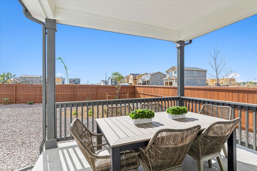 A table and chairs on a deck. A table and chairs on a deck.