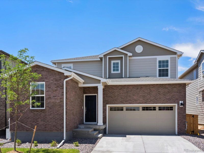 Front exterior of a new home in Ridgeline Vista: The Canyon Collection, Brighton, CO, highlighting curb appeal (Image 1).