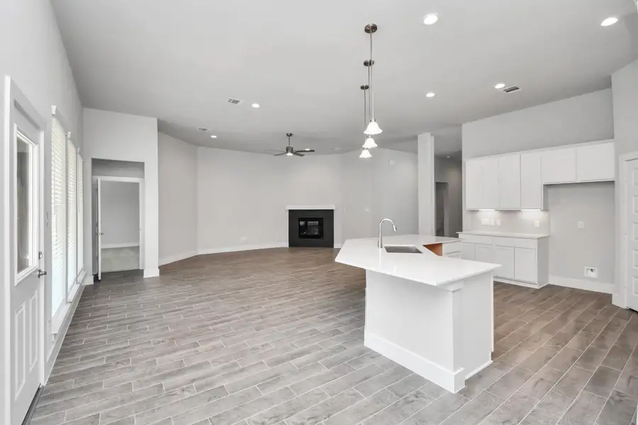 View from the breakfast area to the kitchen and living room. Sample photo of completed home with similar floor plan. Actual colors and selections may vary. View from the breakfast area to the kitchen and living room. Sample photo of completed home with similar floor plan. Actual colors and selections may vary.