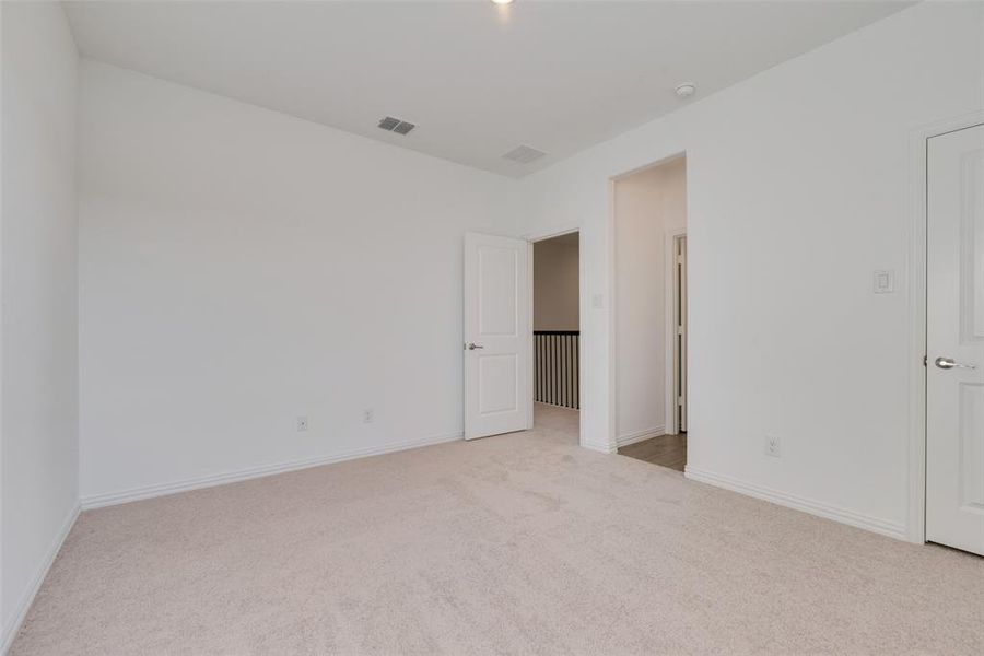 Unfurnished bedroom featuring light carpet