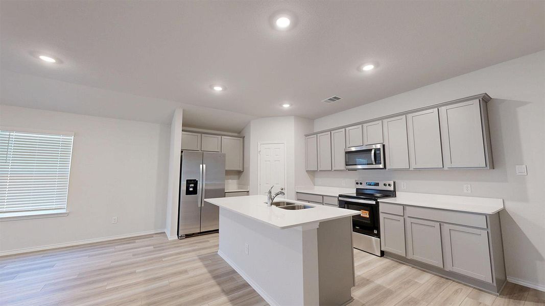 A well-lit kitchen with modern appliances and an inviting kitchen island.