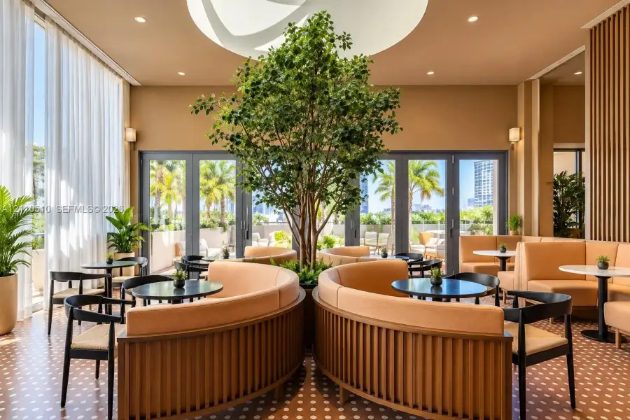 Lounge area featuring a central living tree, recessed ceiling lighting, patterned tile flooring, wood-slat wall paneling, and floor-to-ceiling glass doors Lounge area featuring a central living tree, recessed ceiling lighting, patterned tile flooring, wood-slat wall paneling, and floor-to-ceiling glass doors