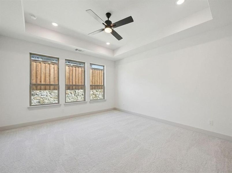 Spacious room featuring clean white walls and new light-toned carpet