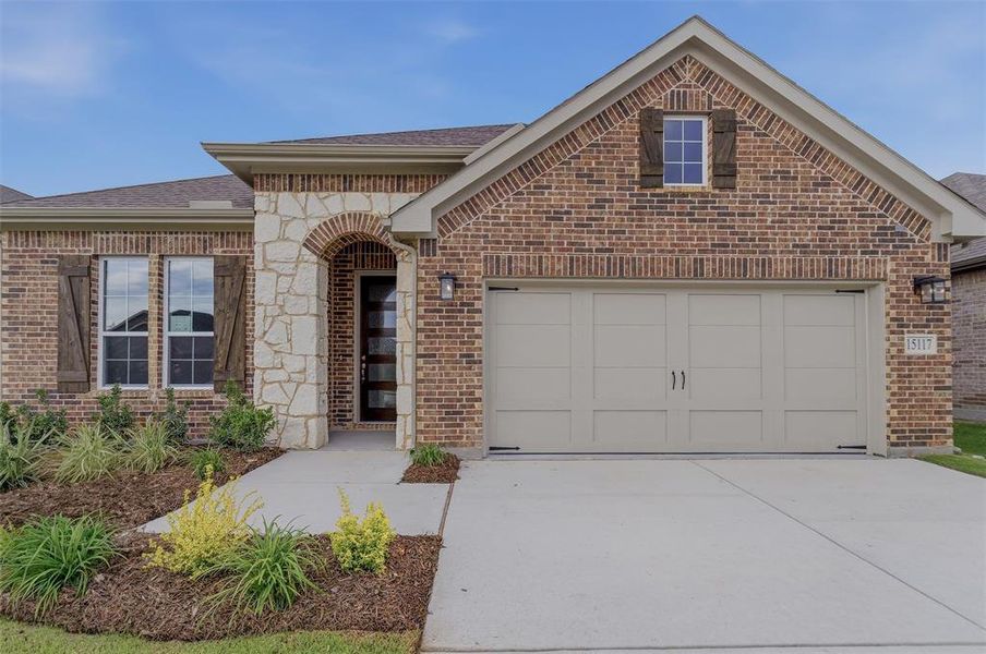 Brick exterior featuring stone accents and decorative shutters