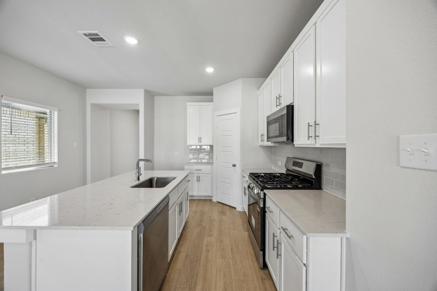 Kitchen in the Birch home plan by Trophy Signature Homes – REPRESENTATIVE PHOTO