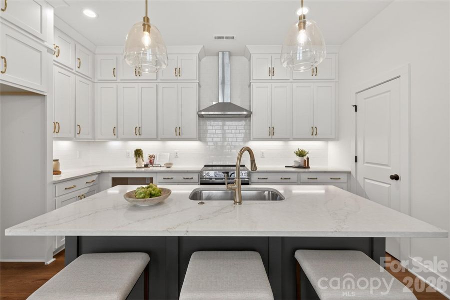 Gourmet Kitchen with Stacked Cabinets & Vented Range Hood