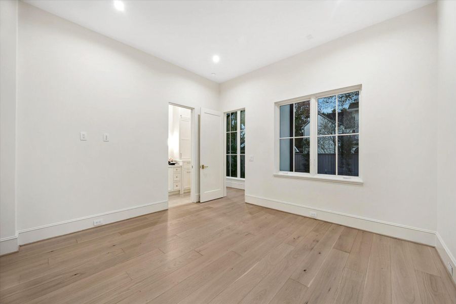 [First Floor Bedroom with Ensuite Bath] Private main-level suite offering flexibility as a guest bedroom, home office, or workout studio.