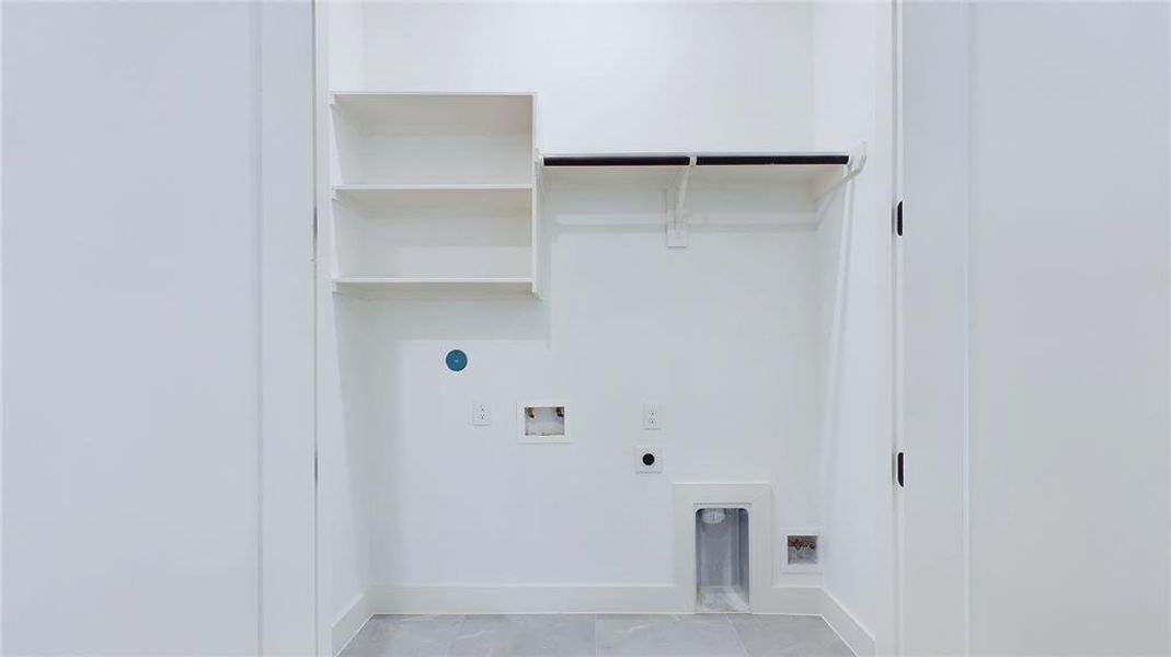 The well-designed utility room features both gas and electric hookups, making it compatible with any washer/dryer system. It also offers additional hanging and shelving space for added convenience and organization.