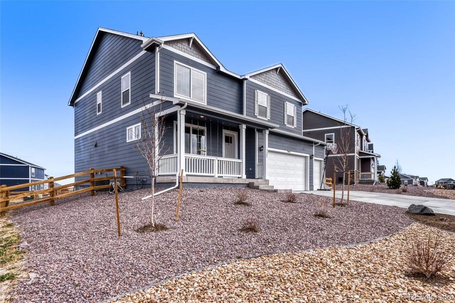 Front exterior of a new home in Spring Valley Ranch, Elizabeth, CO, highlighting curb appeal (Image 24). Front exterior of a new home in Spring Valley Ranch, Elizabeth, CO, highlighting curb appeal (Image 24).