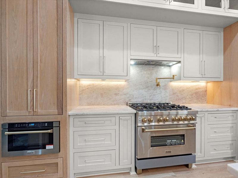 You'll find custom cabinetry throughout, but the details here are; white oak cabinetry, glass face cabinets, luxury appliances, and much much more.