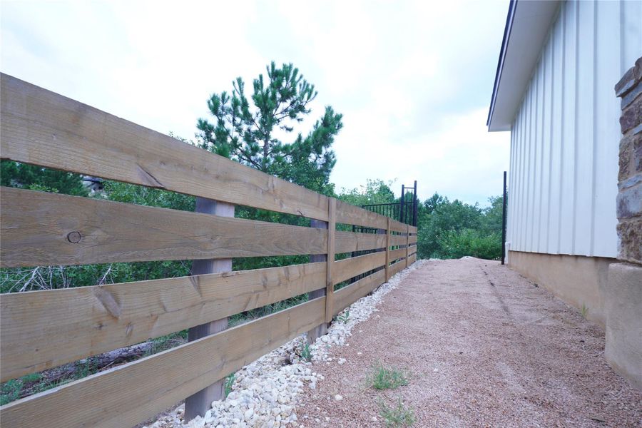 Wooden fence for your protection, next to the home's pathway towards the back patio.