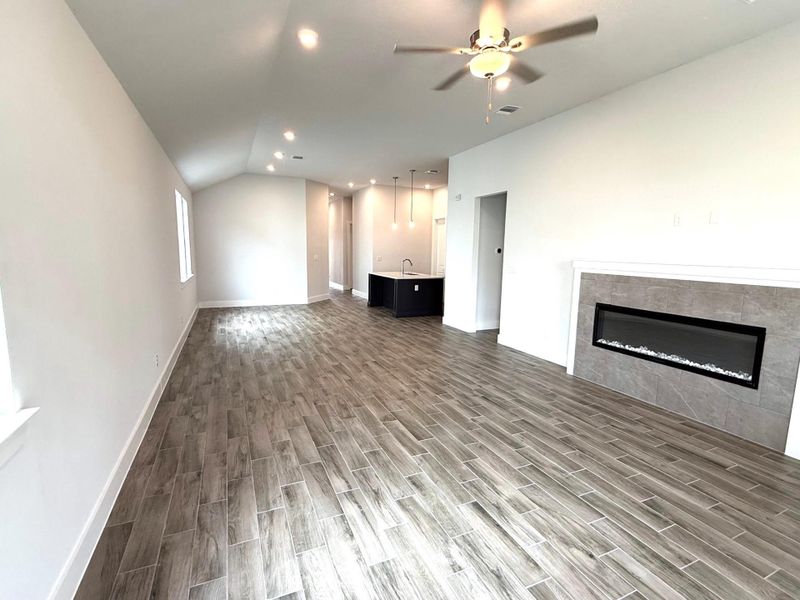 A spacious great room features an inviting fireplace and durable tile flooring throughout.