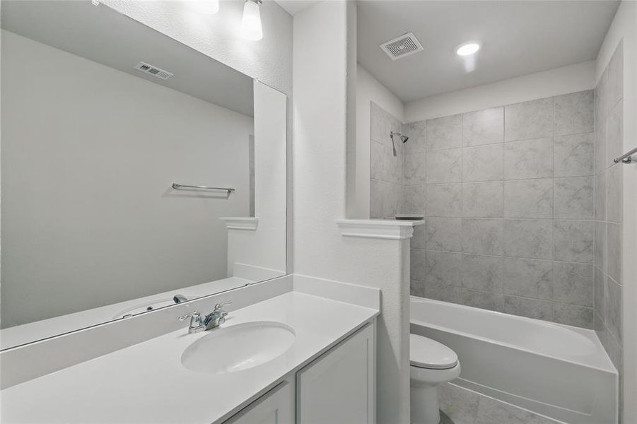 Full bathroom featuring vanity, bathtub / shower combination, and tile patterned floors Full bathroom featuring vanity, bathtub / shower combination, and tile patterned floors