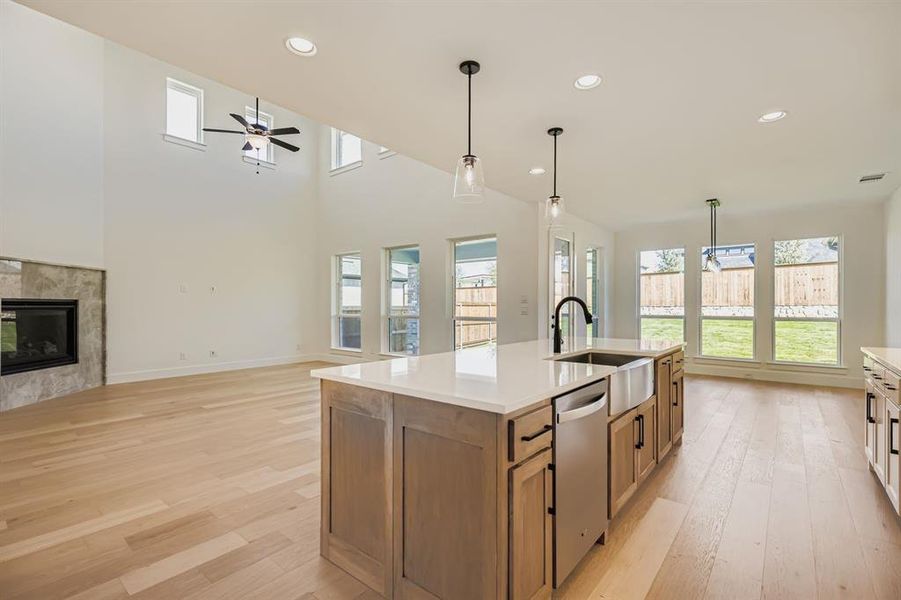 Kitchen featuring brown cabinets, recessed lighting, light wood-style flooring, and pendant lighting Kitchen featuring brown cabinets, recessed lighting, light wood-style flooring, and pendant lighting