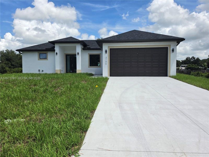 Front exterior of a new home in , Lehigh Acres, FL, highlighting curb appeal (Image 16).