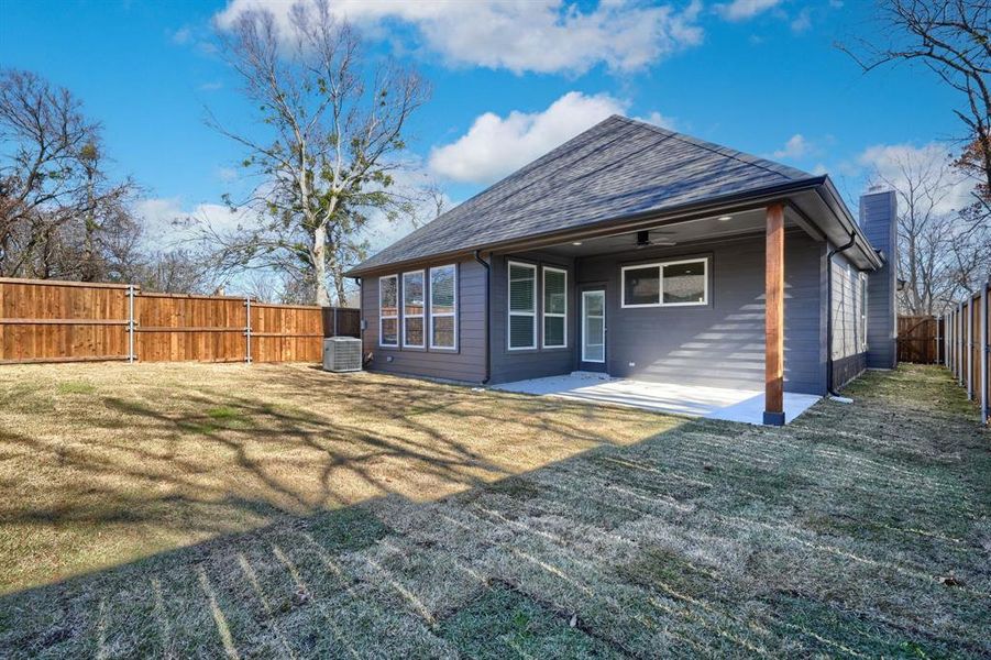 Rear view of property featuring a patio area, ceiling fan, a yard, and central AC unit