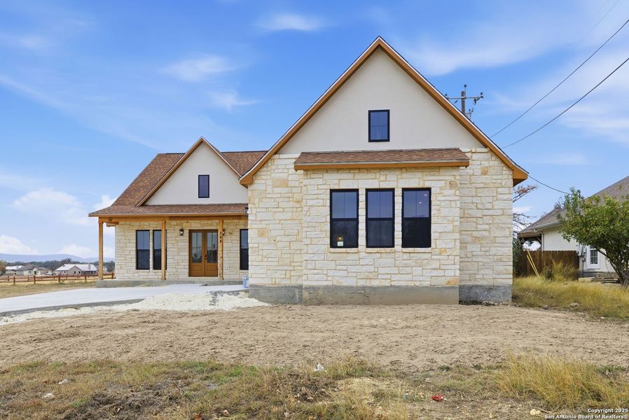 Front exterior of a new home in , Bandera, TX, highlighting curb appeal (Image 27).