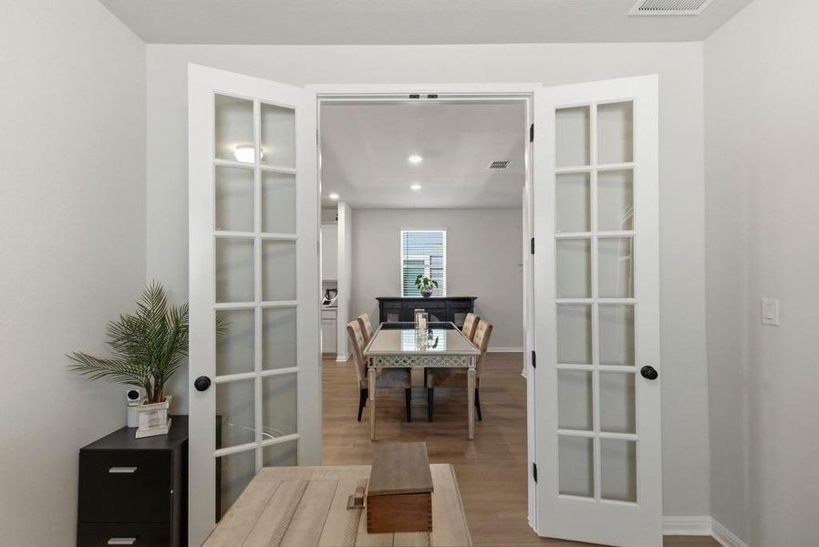 Office featuring wood finished floors, french doors, and recessed lighting