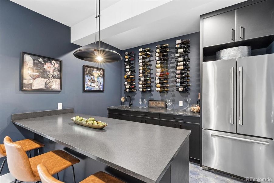 Basement wet bar with built in wall wine racks, a wine fridge, granite countertops as well as a full size JennAir refrigerator Basement wet bar with built in wall wine racks, a wine fridge, granite countertops as well as a full size JennAir refrigerator