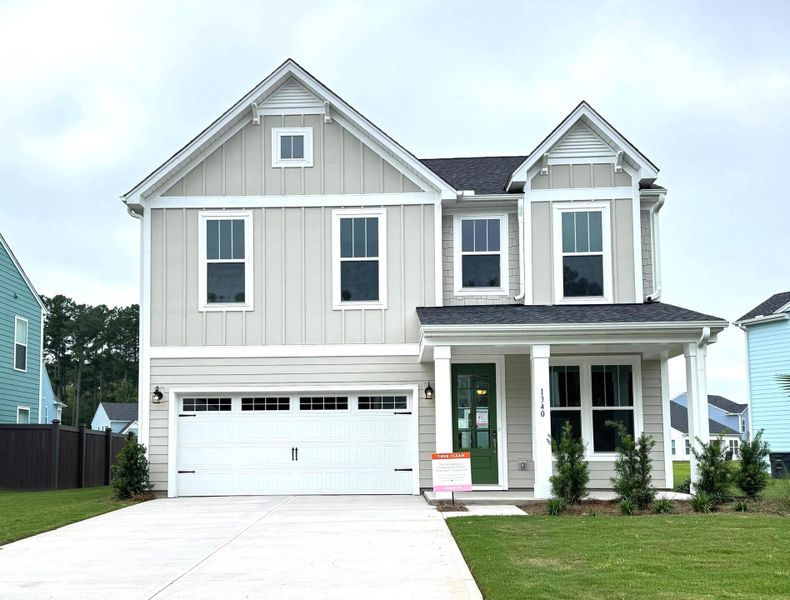 Front exterior of a new home in , Ravenel, SC, highlighting curb appeal (Image 1). Front exterior of a new home in , Ravenel, SC, highlighting curb appeal (Image 1).