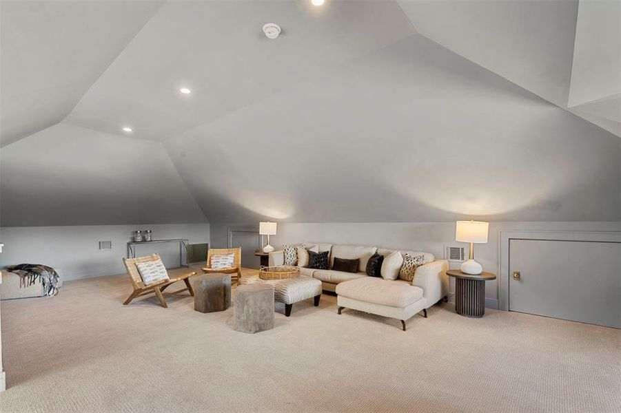 Living room with vaulted ceiling and light carpet