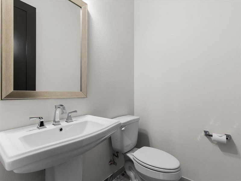 Bathroom with toilet and a textured wall Bathroom with toilet and a textured wall