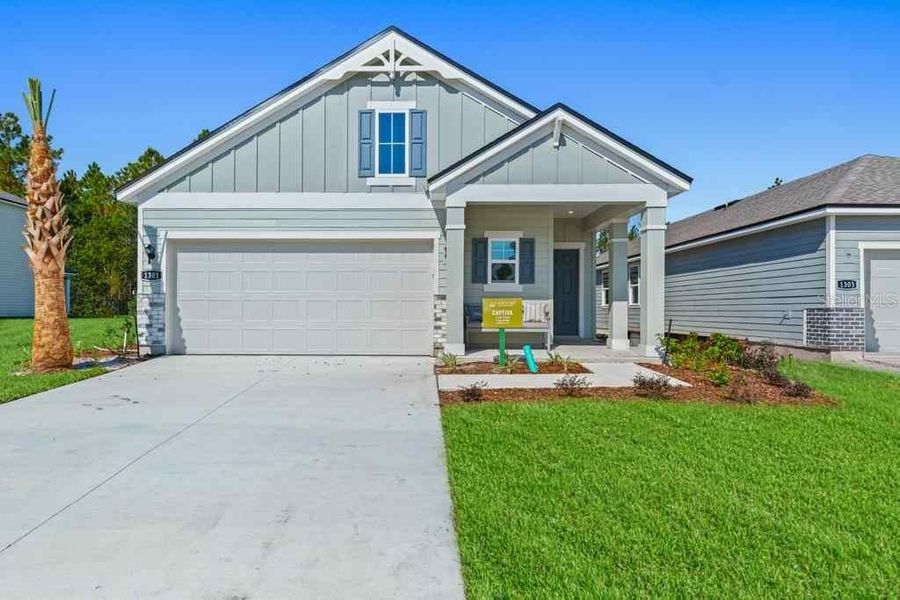 Front exterior of a new home in , Palm Coast, FL, highlighting curb appeal (Image 1). Front exterior of a new home in , Palm Coast, FL, highlighting curb appeal (Image 1).