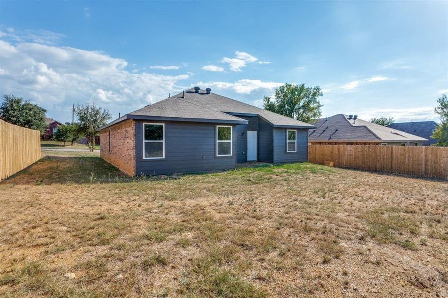 Back of house with roof with shingles
