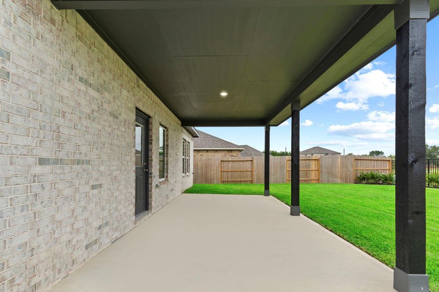 This side view of the extended patio emphasizes its generous size and full overhead cover, providing year-round shade and comfort for relaxing or entertaining outdoors.