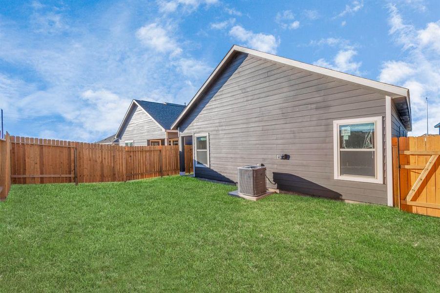 This spacious backyard offers endless possibilities for outdoor living. Whether you envision a garden, play area, or an alfresco dining space, this generously sized yard with a tall wooden fence ensures both privacy and room for creativity. A perfect canvas for creating your personalized outdoor retreat. **This image is from another Saratoga Home - Clover floorplan.**