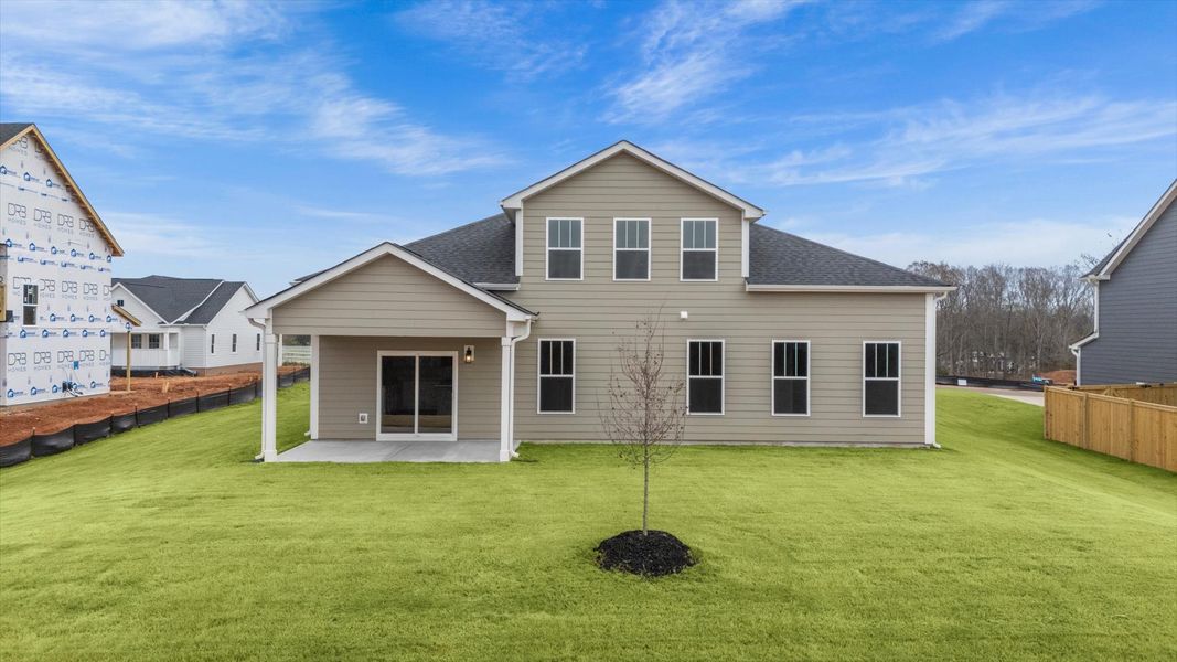Highly functional rear covered porch adds memorable living space to this elegant home