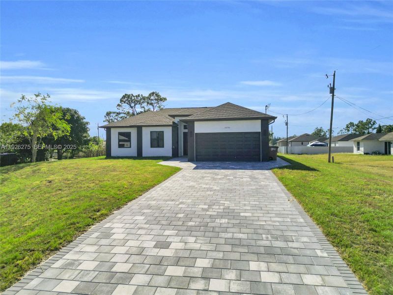 Front exterior of a new home in , Lehigh Acres, FL, highlighting curb appeal (Image 22).
