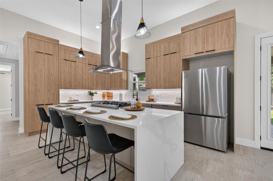 Modern kitchen featuring sleek stainless steel appliances, a spacious island with seating, and elegant wood cabinetry for ample storage.