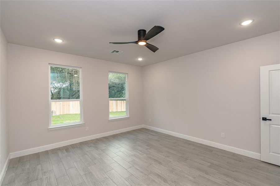 Spare room with ceiling fan and light hardwood / wood-style floors