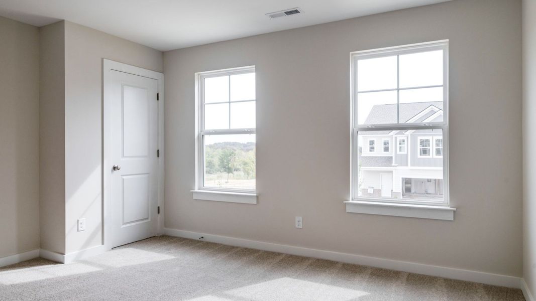 Closet next to windows in secondary bedroom