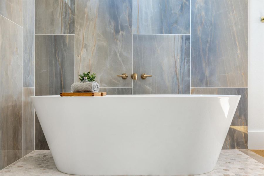 Bathroom wet area with tile walls and a freestanding tub