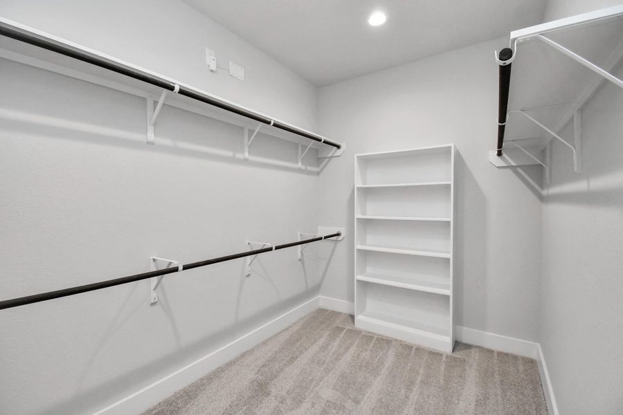 Walk-in closet that epitomizes luxury and practicality. This generously sized space features built-in shelving, offering abundant room for impeccable organization. High ceilings and recessed lighting create a bright and welcoming ambiance. Walk-in closet that epitomizes luxury and practicality. This generously sized space features built-in shelving, offering abundant room for impeccable organization. High ceilings and recessed lighting create a bright and welcoming ambiance.