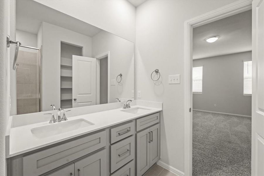 Bathroom featuring an enclosed shower and vanity