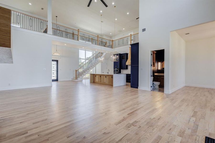 Expansive open-concept living area featuring light wood-finish flooring throughout