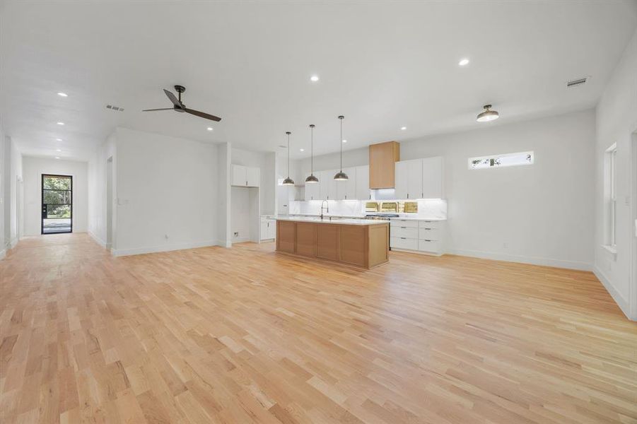 Exquisite natural white oak hardwood flooring flows seamlessly throughout the home, creating a cohesive design, timeless elegance, and a warm, inviting atmosphere. The spacious living, dining and kitchen areas beautifully showcases the rich character and craftsmanship of the hardwoods, serving as a stunning focal point of the home's open-concept design. Exquisite natural white oak hardwood flooring flows seamlessly throughout the home, creating a cohesive design, timeless elegance, and a warm, inviting atmosphere. The spacious living, dining and kitchen areas beautifully showcases the rich character and craftsmanship of the hardwoods, serving as a stunning focal point of the home's open-concept design.