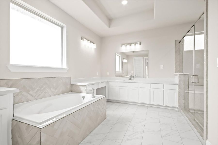 Luxurious owner's bath with dual vanities